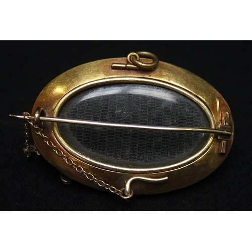 272 - An antique yellow metal mememto-mori brooch/pendant, (tests as 14-15ct gold), of domed oval form, ce... 