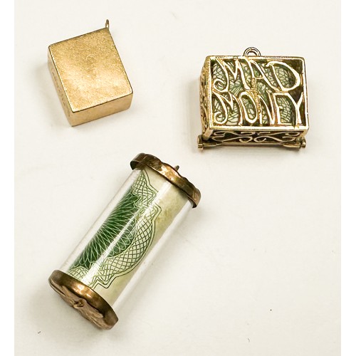 239 - Three various 9ct gold bracelet charms, encapsulated notes, including a Ten Shilling note, a One Pou... 