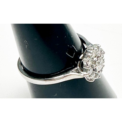 255 - An 18ct white gold diamond ring, claw set with 9 x round brilliant cut diamonds in a daisy cluster d... 