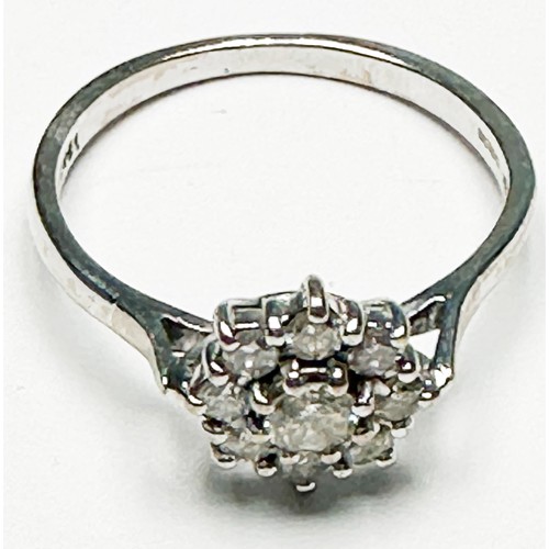 255 - An 18ct white gold diamond ring, claw set with 9 x round brilliant cut diamonds in a daisy cluster d... 