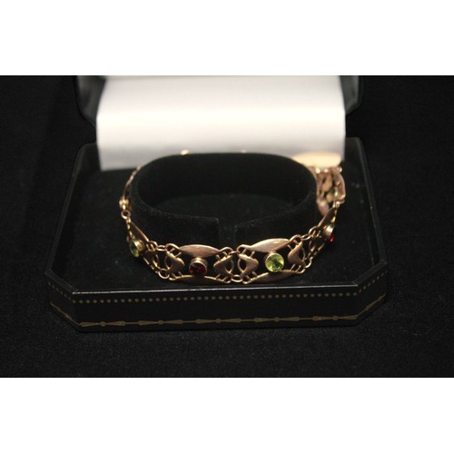 275 - A 9ct gold pierced bracelet, set with alternating green and red round faceted stones, with 9ct gold ... 