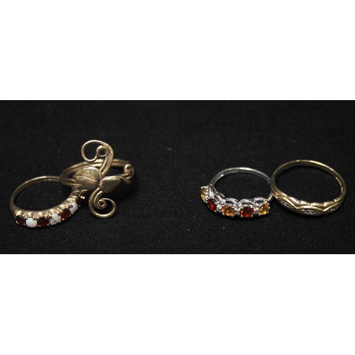 280 - Four various 9ct gold rings, one white gold example set with red and orange coloured stones, another... 