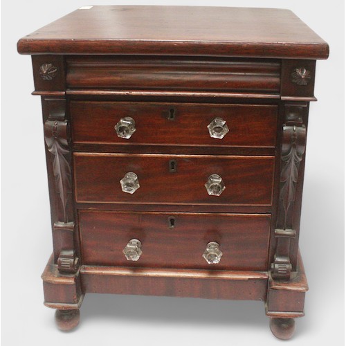 436 - A mahogany table top chest of three graduated drawers with clear plastic pulls, pulvinated frieze dr... 