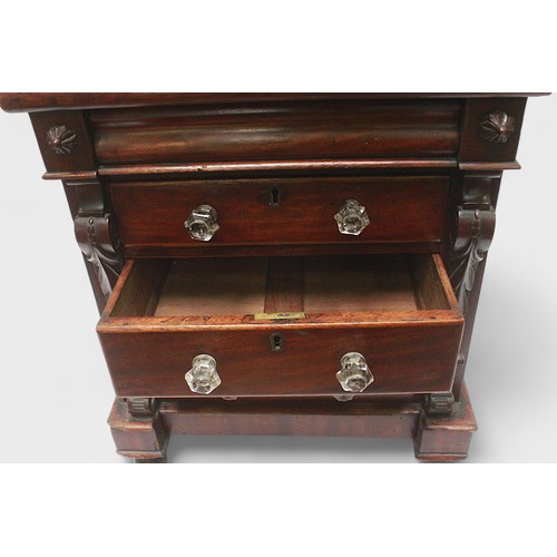 436 - A mahogany table top chest of three graduated drawers with clear plastic pulls, pulvinated frieze dr... 