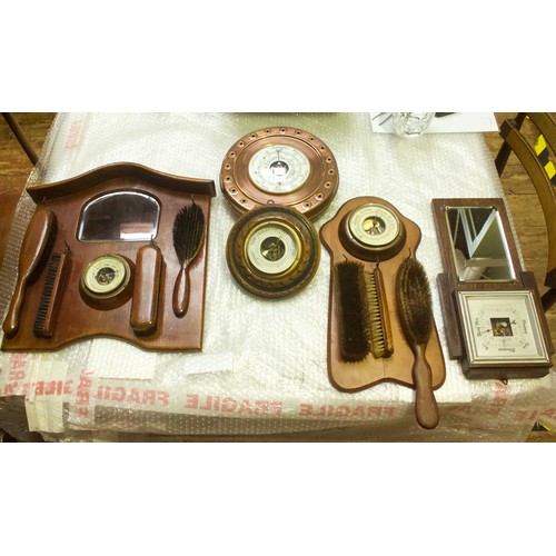 522 - Ten various aneroid barometers, variously mounted on wooden frames including a ships wheels and two ... 