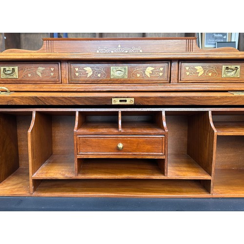 625 - A 20th Century brass inlaid hardwood bureau, cylinder front opens to reveal writing slide and pigeon... 