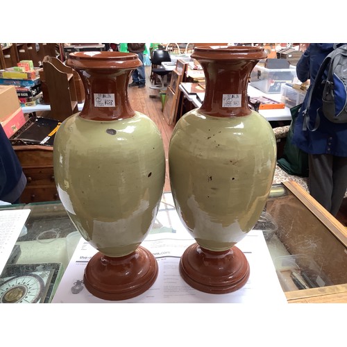 37 - A pair of large glazed stoneware pottery vases, of baluster ovoid form with flared rim and splaying ... 