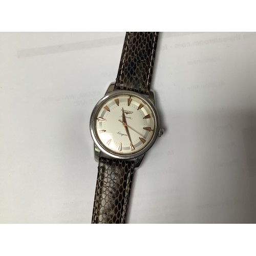 124 - A gents stainless steel Longines Conquest Automatic wristwatch, the silvered dial with applied gilt ... 