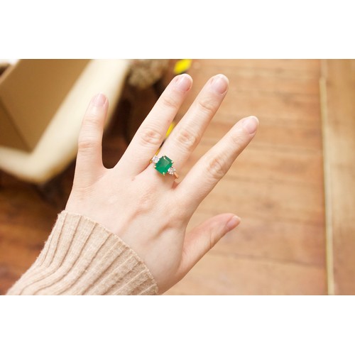 167 - An 18ct gold dress ring, four-claw set with a rectangular-shaped emerald, measuring approximately 10... 