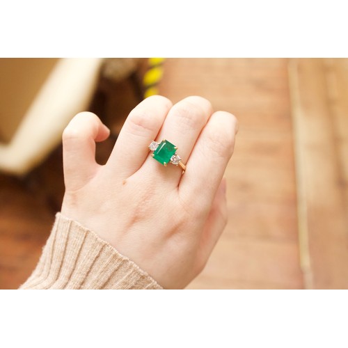 167 - An 18ct gold dress ring, four-claw set with a rectangular-shaped emerald, measuring approximately 10... 