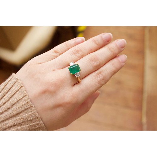 167 - An 18ct gold dress ring, four-claw set with a rectangular-shaped emerald, measuring approximately 10... 