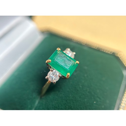 167 - An 18ct gold dress ring, four-claw set with a rectangular-shaped emerald, measuring approximately 10... 