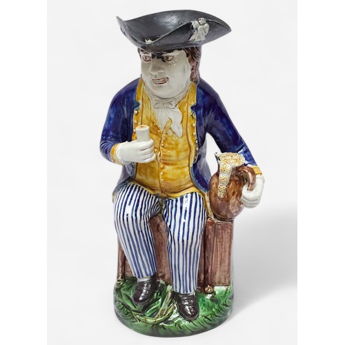 32 - A Prattware ‘Sailor’ toby jug, c1790-1810, black tricorn hat, blue striped britches, overflowing bro... 