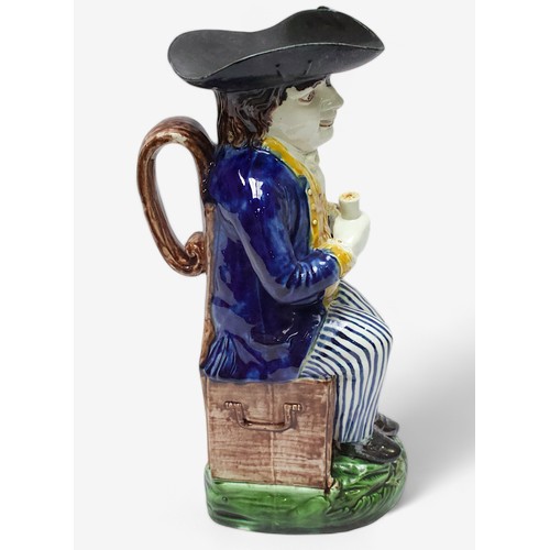 32 - A Prattware ‘Sailor’ toby jug, c1790-1810, black tricorn hat, blue striped britches, overflowing bro... 