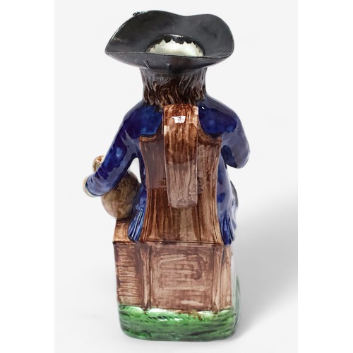 32 - A Prattware ‘Sailor’ toby jug, c1790-1810, black tricorn hat, blue striped britches, overflowing bro... 