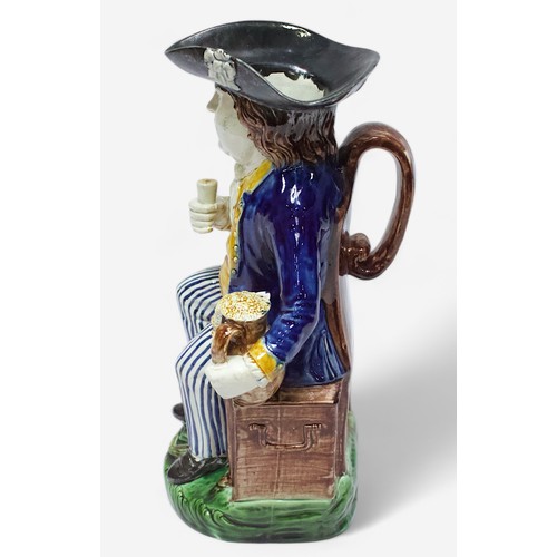 32 - A Prattware ‘Sailor’ toby jug, c1790-1810, black tricorn hat, blue striped britches, overflowing bro... 