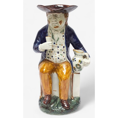 35 - A Prattware Pottery ‘Sailor’ toby jug, c1790-1810, with blue coat and floral painted waistcoat and m... 