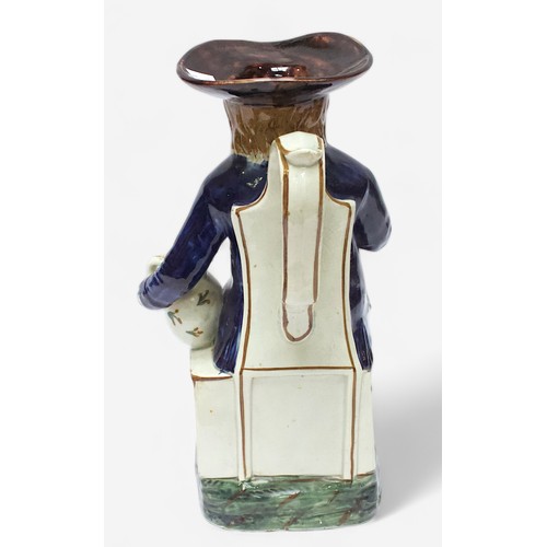 35 - A Prattware Pottery ‘Sailor’ toby jug, c1790-1810, with blue coat and floral painted waistcoat and m... 