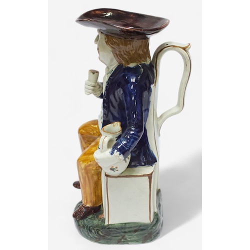 35 - A Prattware Pottery ‘Sailor’ toby jug, c1790-1810, with blue coat and floral painted waistcoat and m... 