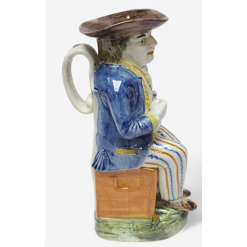 36 - A Prattware Pottery ‘Sailor’ toby jug, c1790-1810, seated holding a jug, striped britches, blue coat... 