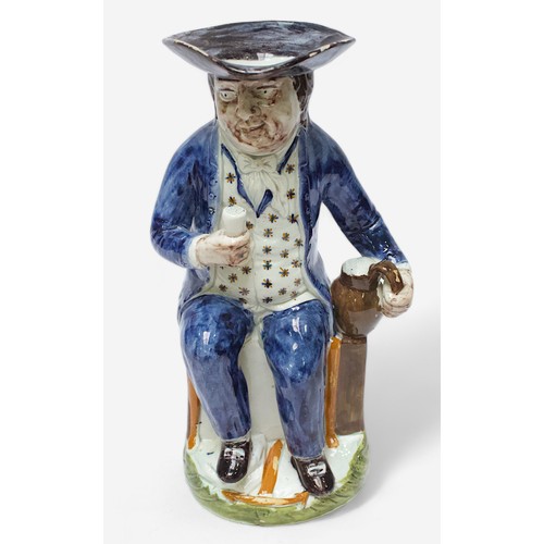 34 - A Prattware ‘Sailor’ toby jug, c1790-1810, blue frockcoat and britches, waistcoat painted with stars... 