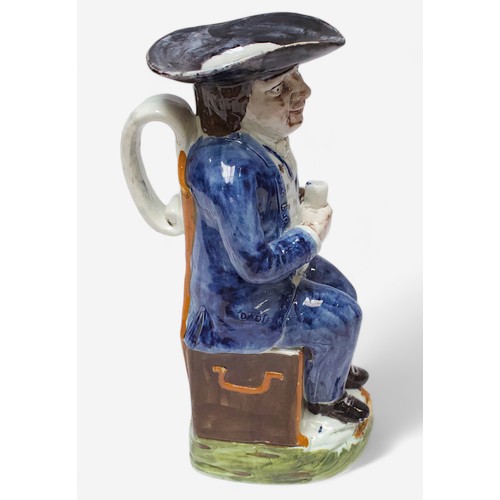 34 - A Prattware ‘Sailor’ toby jug, c1790-1810, blue frockcoat and britches, waistcoat painted with stars... 