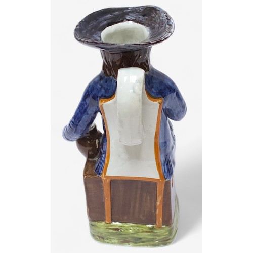 34 - A Prattware ‘Sailor’ toby jug, c1790-1810, blue frockcoat and britches, waistcoat painted with stars... 