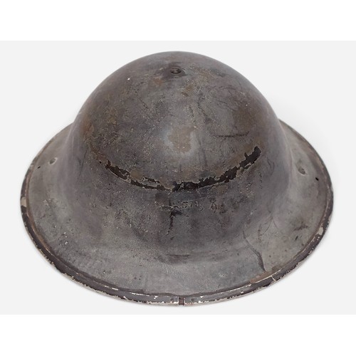 52 - A British WWII Air Raid Wardens Brodie helmet, with leather liner and khaki webbing chin strap, toge... 