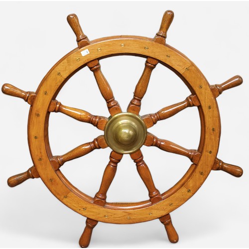 21 - An eight spoke oak ships wheel, with brass central hub and cone, and flush brass screws, 108cm diame... 