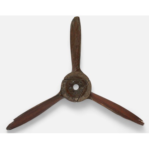 110 - An early 20th Century three-blade wooden propeller, nine interlocking laminate mahogany construction... 