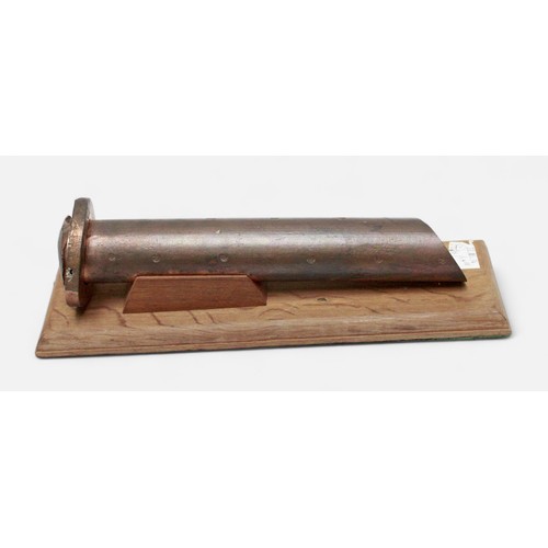 171 - A large copper rivet, with multiple broad arrow stamps and mounted on fitted wooden stand, 33cm long... 