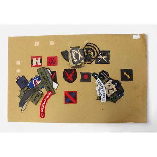 190 - Fifteen card sheets displaying a good collection of assorted cap badges and patches including exampl... 