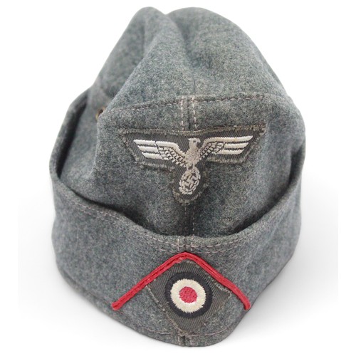 262 - A WWII German Third Reich Overseas Artilery M38 Side cap, with original bevo cap eagle and cockade t... 