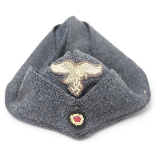 262 - A WWII German Third Reich Overseas Artilery M38 Side cap, with original bevo cap eagle and cockade t... 