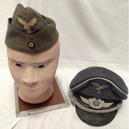 296 - A German WWII Third Reich Luftwaffe side cap, together with a reproduction German WWII Third Reich L... 