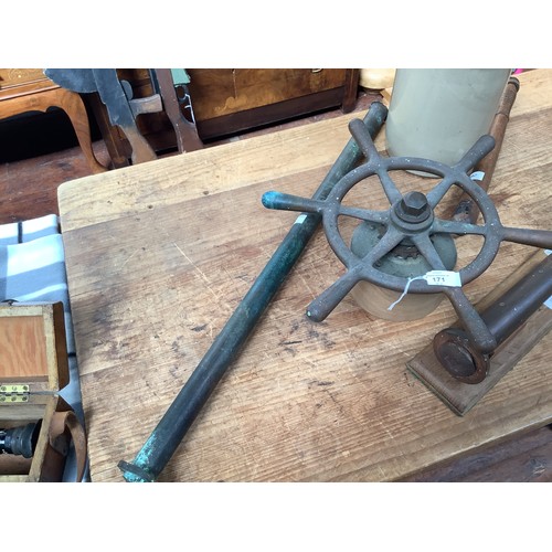 171 - A large copper rivet, with multiple broad arrow stamps and mounted on fitted wooden stand, 33cm long... 