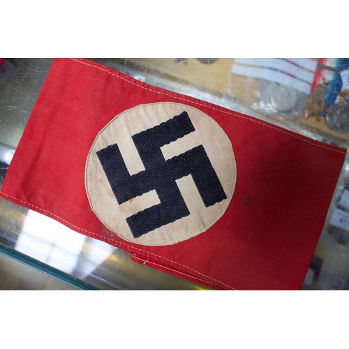 264 - A WWII German Third Reich Swastika pennant, together with an armband, another felt armband and flag.... 