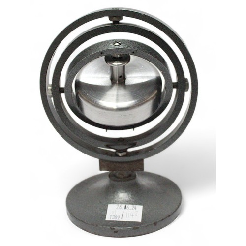 455 - A table top 3-axis metal gyroscope, raised on spreading circular foot, 19cm tall, together with a bo... 