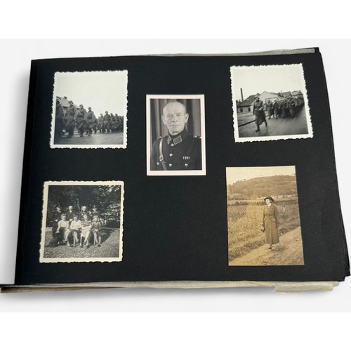 585 - A WWII German Third Reich photogrpah album, the front cover embossed with the Reichsadler and the wo... 