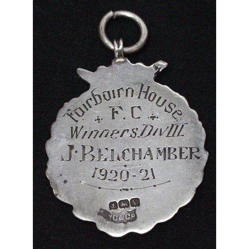 75B - A silver and enamel West Ham & District Football League winner’s medal, set with yellow-metal (proba... 