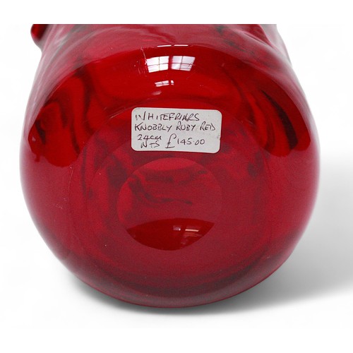 139B - A large Whitefriars ruby red ‘knobbly’ vase, design after William Wilson and Harry Dyer, 24cm