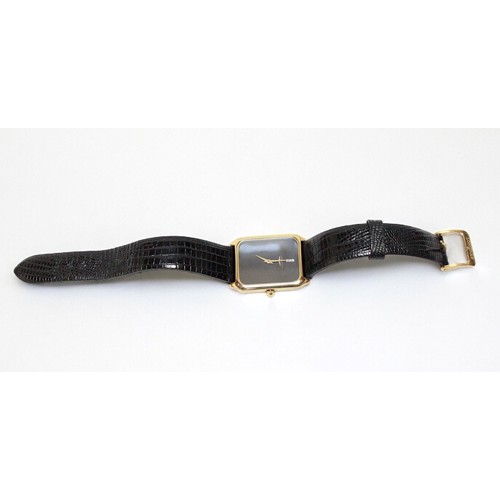 203 - A 9ct gold cased tank style Longines wristwatch, C.1977, the rectangular plain black dial with no ho... 