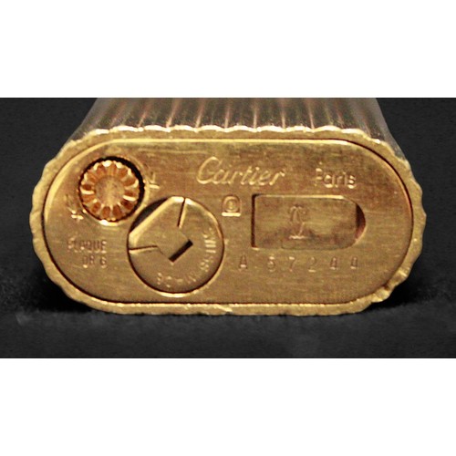 463 - A gold-plated Must de Cartier lighter, of rectangular form with rounded ends and reeded pattern to s... 