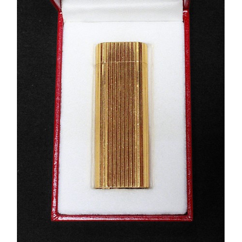 463 - A gold-plated Must de Cartier lighter, of rectangular form with rounded ends and reeded pattern to s... 