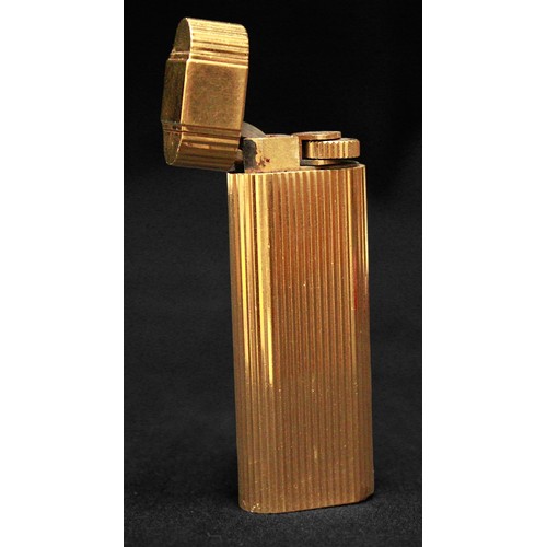 464 - A gold-plated Must de Cartier lighter, of rectangular form with rounded ends and reeded pattern to s... 