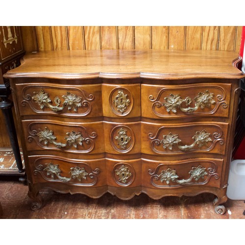 717 - An 18th Century mahogany commode chest of serpentine outline, with foliate gilt bronze mounts and es... 