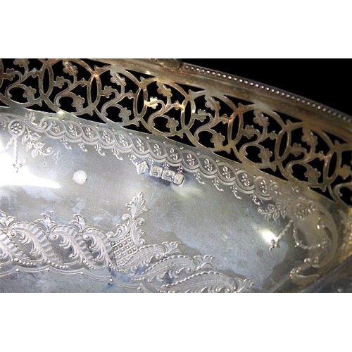 148 - A late Victorian pierced silver bread basket by Martin, Hall & Co. With beaded rim and hinged handle... 