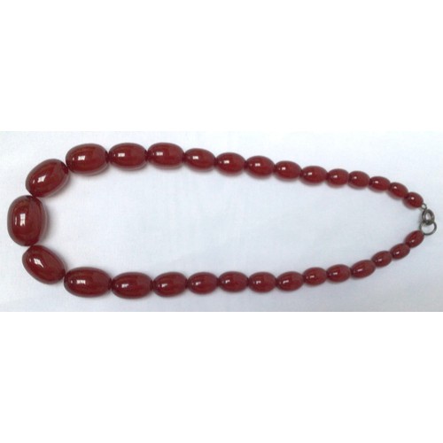 262 - Two strands of graduated oval cherry amber coloured beads, the smaller strand with silver clasp, the... 