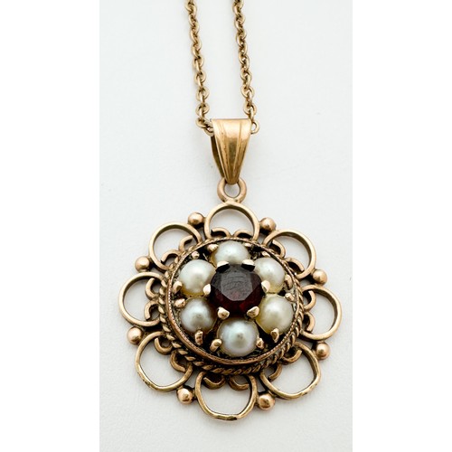 248 - A 9ct gold pendant, set with a central garnet surrounded by seed pearls, with filigree decoration, s... 