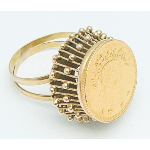 270 - An 18ct gold dress ring, high  set with a 22ct gold Persian coin to the centre, weighs 6.4 grams.